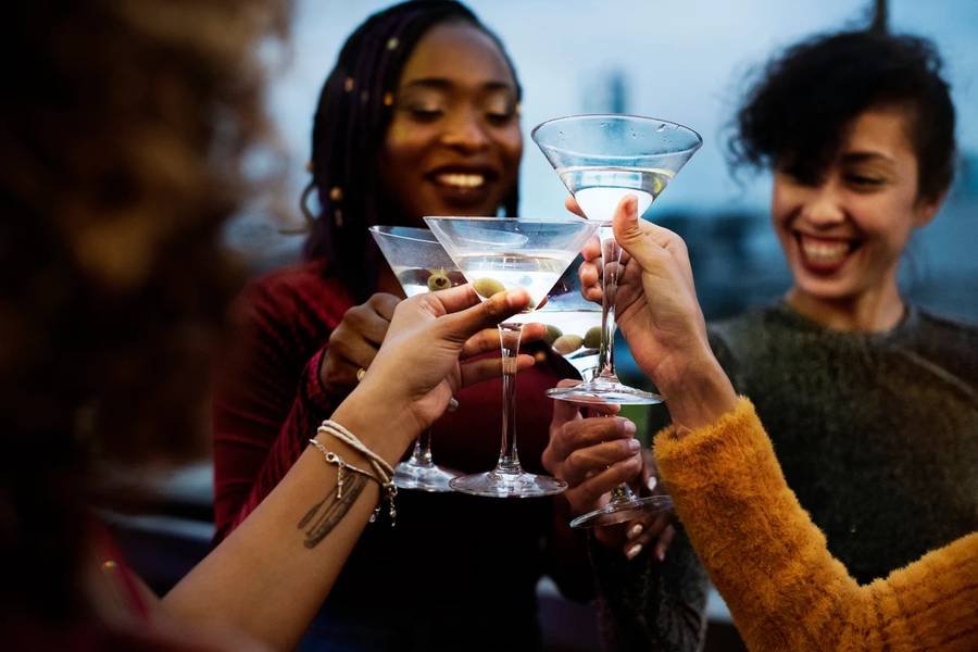 Guests raising cocktails together at a celebration
